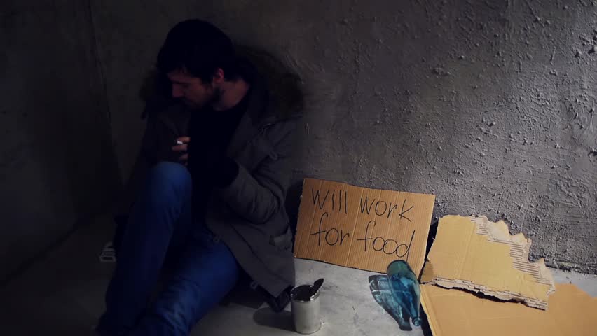 homeless sitting in the corner and smoking