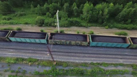 Freight train carries with coal an electric locomotive by two-sided railway in Ural Mountains - Aerial Photography, top view