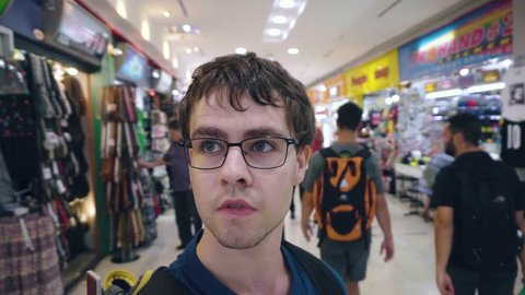 European backpacker face looking around in shopping center - MBK, Bangkok, Thailand - September 2017