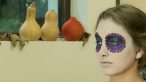 Make-up artist applying Halloween face art - 4K closeup video