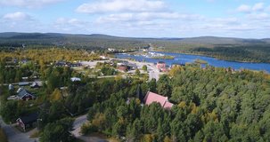 Arctic town, Cinema 4k aerial towards view the church and Inari town, on a sunny autumn day, in Lapland, Finland