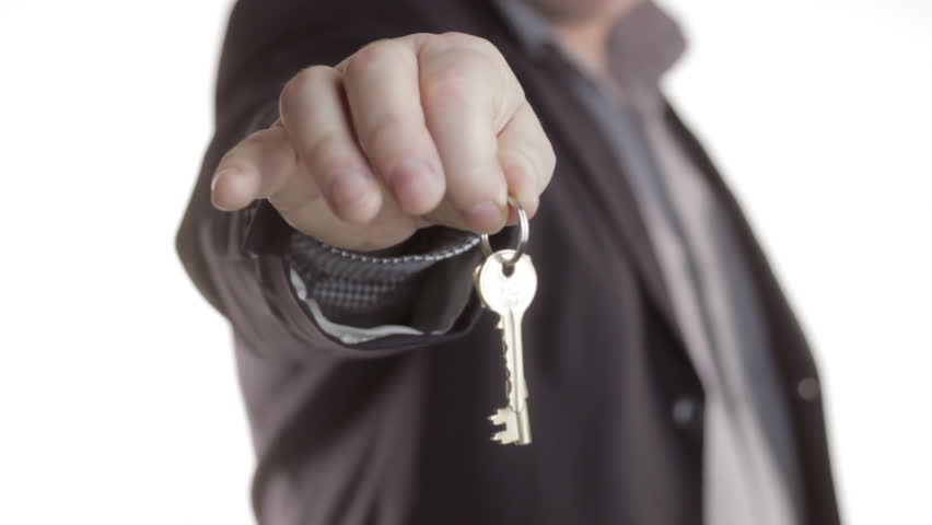 Man holding up house keys