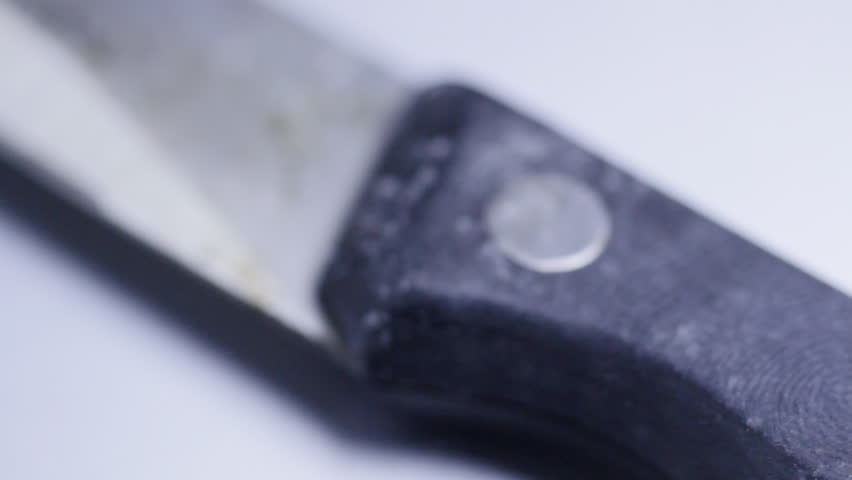 Pan over fingerprint on knife handle, CU