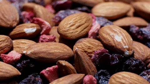 Healthy and delicious mix of almonds and dry red fruits close up. rotation of dry fruits and nuts. Food and drinks background. gastronomy concept. gourmet dietry and healthy food concept. organic food