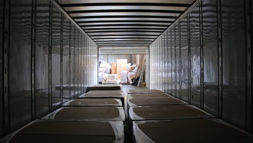 Worker on the loader unload semi-trailer. Shooting from inside of the trailer. Timelapse. Royalty-Free Stock Footage #33155524