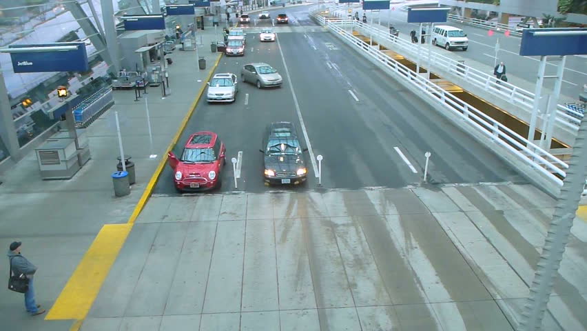 PORTLAND, OREGON AIRPORT - CIRCA 2012: Cars driving and people traveling at