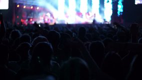 Shot of some cheering fans at a life concert, slow motion, some visible noise due high ISO, soft focus, also normal speed version of this video available in my portfolio