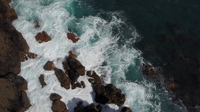 Aerial shots - Drone Video of wild waves of Atlantic ocean  knocking on the rocks in a sunny summer day in Gran Canaria - Canary islands - Spain