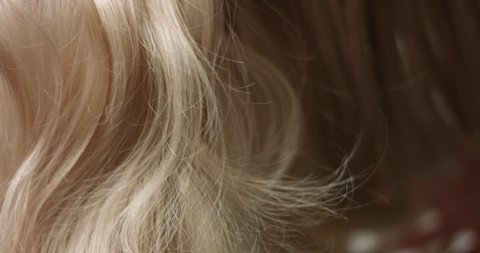 Close up video of woman's long wavy blond hair