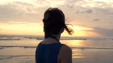 Pensive woman admire sunset on beach, super slow motion 240fps

