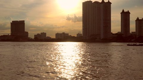 Evening Chao Phraya waterfront view in Thailand
