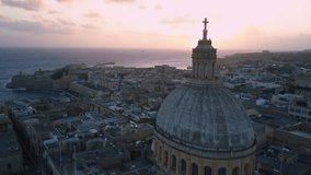 4k drone - Basilica Of Our Lady Mount Carmel at sunrise.  Ancient medieval city of Valletta, Malta.  Island nation of Europe in the Mediterranean Sea.