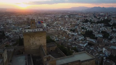 4k aerial drone footage - Tourists atop the medieval castle, The Alhambra, at sunset.  Granada, Spain.  This ancient fortress was built by the Moorish Caliphate.  