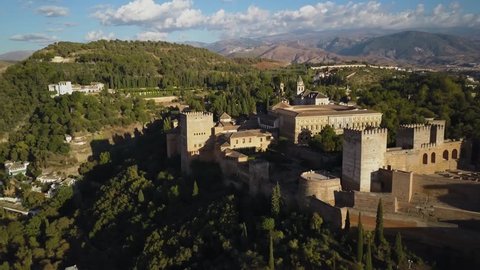 4k aerial drone footage - Ancient medieval castle, The Alhambra, of Granada Spain at sunset.  This mighty fortress was built by the Moorish Caliphate when they controlled much of Spain.  