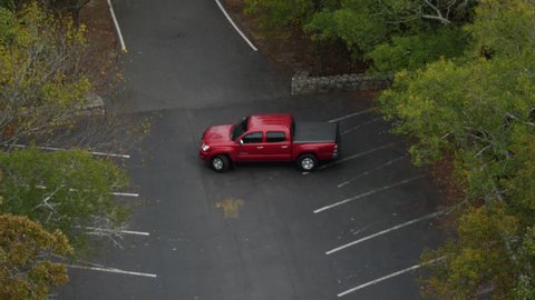Hope Springs Arkansas - October 2017 : Aerial View of Red Pickup Truck Parking in Lot Forest After Trip