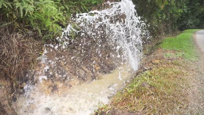 wasting water, water pipe leaking at roadside.