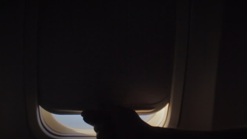 Man opens an airplane window and looks out during air travel. Happy. Man traveling by plane together. Tourism concept Royalty-Free Stock Footage #33193423