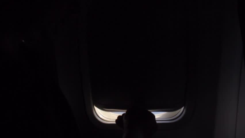 Man opens an airplane window and looks out during air travel. Happy. Man traveling by plane together. Tourism concept Royalty-Free Stock Footage #33195778