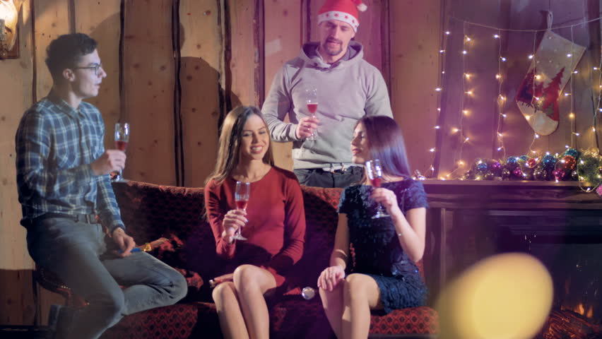 A close group of friends drinks wine to celebrate New Year. 