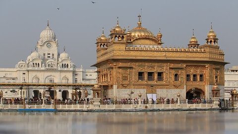 AMRITSAR, INDIA - SEPTEMBER 27, 2014: Unidentified Sikhs and indian people visiting the Golden Temple in Amritsar, Punjab, India. Sikh pilgrims travel from all over India to pray at this holy site