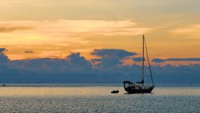 Travel video Sailboat or yacht floating in the sea with sunset in transportation concept