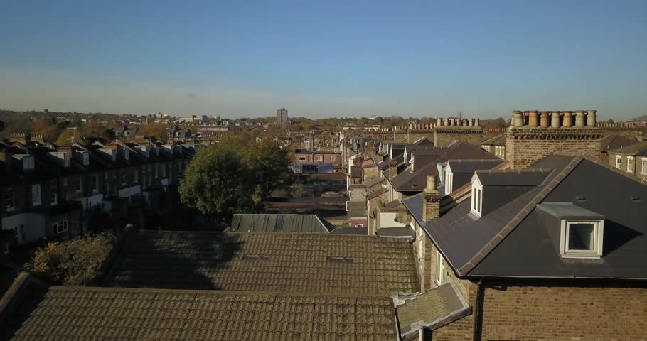 Aerial drone footage, sweeping shot of residential buildings in North London, UK.