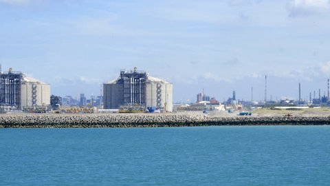 LNG storage tanks in Liquefied Natural Gas Terminal, with an oil refinery in background,  Dunkerque, France