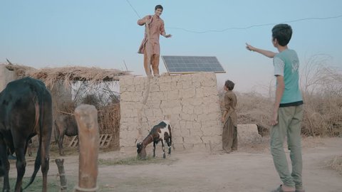 Villagers set up solar panel on the roof top, to bring in electricity in their small town village