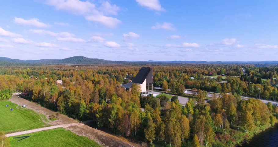 Arctic church, Cinema 4k aerial view towards a church, over Ivalojoki river, on a sunny autumn day, in Ivalo, Lapland, Lappi, Finland