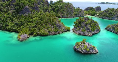 AERIAL: Pianemo Islands, Blue Lagoon with Green Rocks, Raja Ampat, West Papua, Indonesia. 