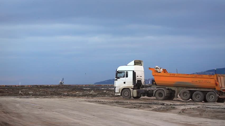 Running dump truck and horn noise at the construction site 
