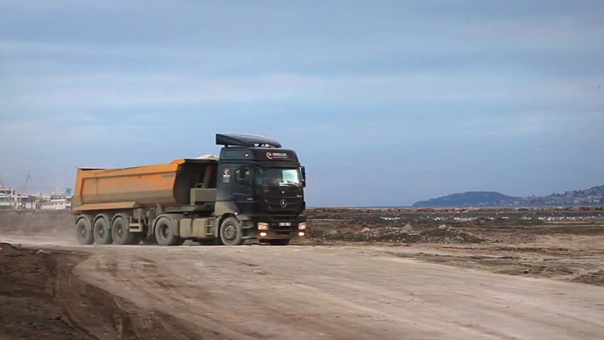 ISTANBUL - DEC 30: Heavy duty dump trucks work for formation of new land by