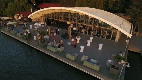 Aerial view of a restaurant near the lake at sunset