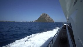 Video of Tavolara island and a yacht cruising towards it. Sardinia. Costa Smeralda.