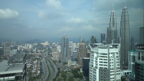 Kuala Lumpur, Malaysia - November 4, 2017: 4k b-roll cinematic footage of cloudy sky at Kuala Lumpur city skyline overlooking the famous Petronas Twin Towers KLCC, aerial view. 