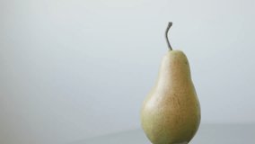 Tilting over organic pear on wooden  table 4K 2160p UltraHD footage - Single fruit from genus Pyrus slow tilt 3840X2160 UHD video