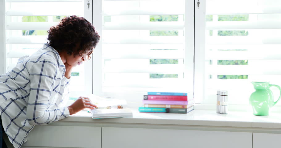 Woman reading a novel at home 4k
