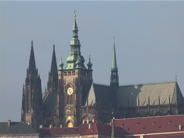 Prague winter panorama of Prague castle, Charles bridge and st. Nicholas church over Vltava river with seagulls. Zoom out.
