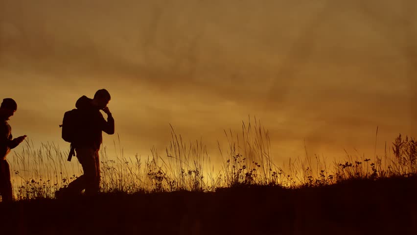 people go group travel of tourists field nature of a sunset silhouette two people travel. tourists nature go people lifestyle group