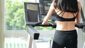 Video Asian beautiful sport woman running on runner machine on morning sunshine, concept healthy and focus with success target
