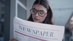Young woman reading newspaper in outdoors - Powered by Shutterstock - Get 15% off with code: PIKWIZARD15