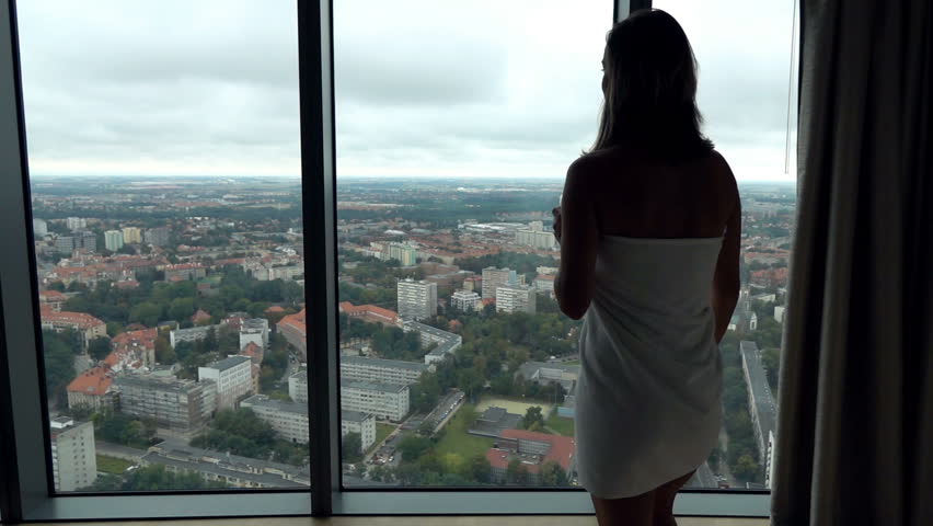 Sexy woman in towel with beverage admire view from window, super slow motion 240fps
 | Shutterstock HD Video #33285289