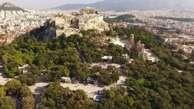 Aerial birds eye view video taken by drone of iconic Acropolis hill and the Parthenon, Athens historic center, Attica, Greece