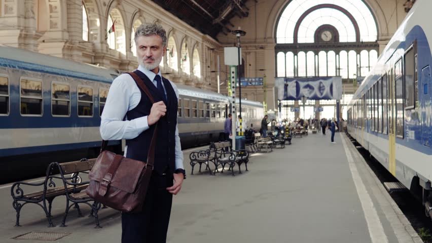 Mature businessman on a train station.