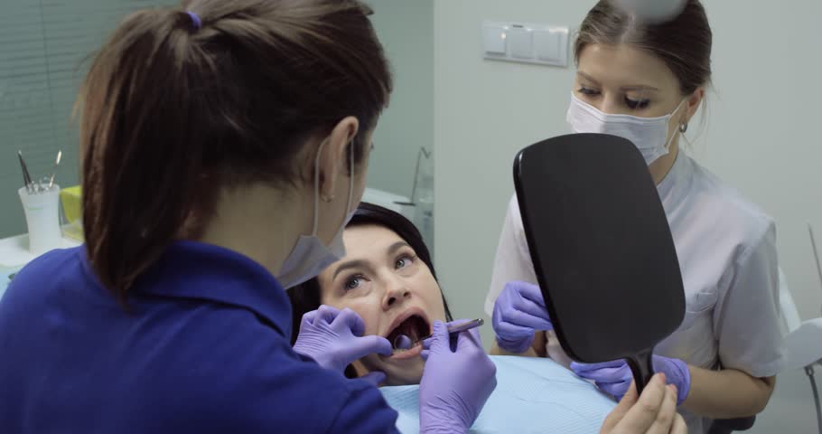 Dentist are checking the teeth using the mirror and nurse are sits beside | Shutterstock HD Video #33293026