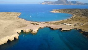 Aerial drone view video of beautiful volcanic caves of Xylobatis or Ksylobatis and famous beach of Pori with deep blue waters, Koufonissi island, Cyclades, Greece