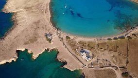 Aerial birds eye view video taken by drone depicting beautiful round beach of Pori  with deep blue - turquoise waters, Koufonisi island, Cyclades, Greece