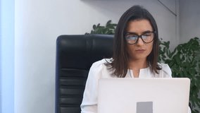 Businesswoman in office with laptop computer