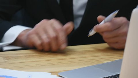 the chief signs the documents that the secretary brings. close up