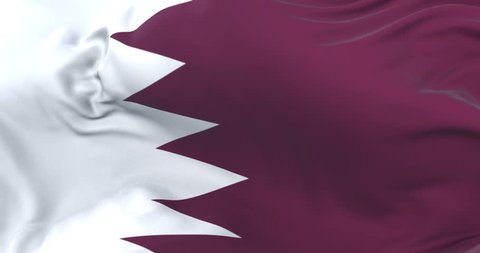 Qatar flag waving at wind in slow with blue sky, loop